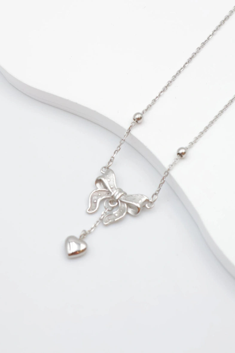 Collier avec motif nœud et pendentif cœur. - ARGENT