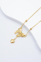 Collier avec motif nœud et pendentif cœur. - DORÉ